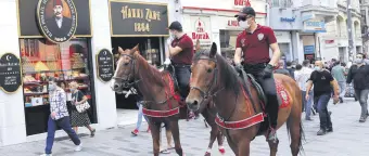  ??  ?? Mounted police officers on patrol against people not wearing protective masks, in Istanbul, Turkey, Sept. 26, 2020.