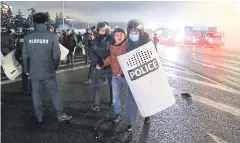  ?? REUTERS ?? Kazakh law enforcemen­t officers detain a man during a protest in Almaty yesterday.