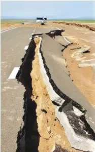  ??  ?? A road in Umnugovi cracks open after flood