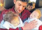  ?? AP FILE ?? Not another one: AbdulHamid Alyousef holds his twin babies who were killed during a suspected chemical weapons attack in Syria’s Khan Sheikhoun in April.