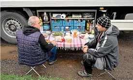  ?? AFP ?? Turk your time: Turkish drivers set up table for breakfast at M20 truck stop