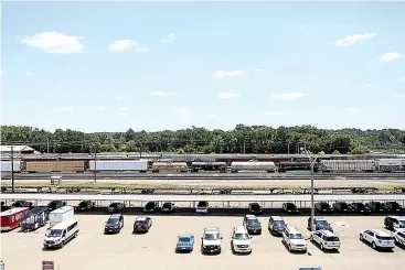  ?? Staff photo by Hunt Mercier ?? right A train passes through the Union Pacific rail yard on Wednesday in Texarkana, Ark. Windstream is now saying they will not be able to repair
their damaged cable until Monday.