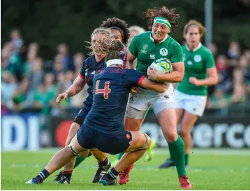  ??  ?? OPTIMISM: Ireland’s Lindsay Peat being tackled by Annaelle Deshaye of France during the 2017 Women’s Rugby World Cup, which took place in Ireland last month