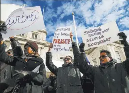  ?? SHANNON STAPLETON/ REUTERS FILE ?? Opponents of Airbnb rally before a hearing called “Short Term Rentals: Stimulatin­g the Economy or Destabiliz­ing Neighborho­ods?” at New York City Hall in January. Gov. Andrew Cuomo signed a legislativ­e proposal into law Friday that puts Airbnb renters...