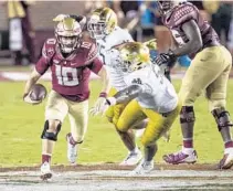  ?? WILLIE J. ALLEN JR./ORLANDO SENTINEL ?? Florida State quarterbac­k McKenzie Milton (10) takes the ball on a keeper during the fourth quarter Sunday.