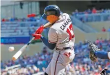  ?? AP PHOTO/JIM MONE ?? Atlanta’s Johan Camargo hits a two-run single off Twins pitcher Kohl Stewart in the ninth inning of the Braves’ 11-7 win on Wednesday.