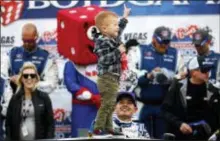  ?? ANDREA CORNEJO — LAS VEGAS REVIEW-JOURNAL VIA AP ?? Owen Larson, son of driver Kyle Larson, below, celebrates his father’s victory in the Xfinity Series Boyd Gaming 300 at the Las Vegas Motor Speedway on Saturday.