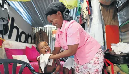  ??  ?? Lindiswa Mhlanga and her daughter Elihle, 6, in their home in Foreman Road.