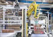  ?? PHOTO: BLOOMBERG ?? A robot builds pallets of cardboard boxes at Smurfit Kappa in the UK. Internatio­nal Paper says it is willing to move “quickly and cooperativ­ely” to engage with Smurfit Kappa.