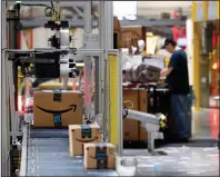  ?? (AP) ?? Packages pass through a scanner at an Amazon fulfillmen­t center in Baltimore in this file photo.