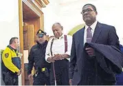 ?? [MARK MAKELA/POOL PHOTO VIA AP] ?? Bill Cosby, center, leaves the courtroom after he was sentenced Tuesday in Norristown, Pa., to three to 10 years for felony sexual assault.