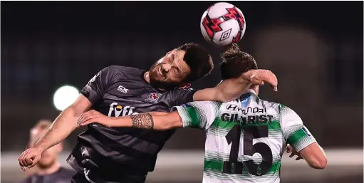  ?? SEB DALY/SPORTSFILE ?? Dundalk’s Patrick Hoban challenges Shamrock Rovers’ Ally Gilchrist during last night’s League of Ireland clash