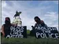  ?? STEVE HELBER — THE ASSOCIATED PRESS ?? Protesters gather around the statue of Confederat­e Gen. Robert E. Lee in Richmond, Va., on Tuesday.