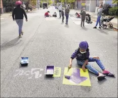  ?? Paul Buckowski / Times Union ?? Ah'jhanay Jones, 12, stencils a design on Sixth Street on Monday as part of Troy’s census mural project.