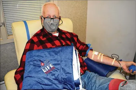  ??  ?? Gene Glover celebrates milestone 150th blood donation.