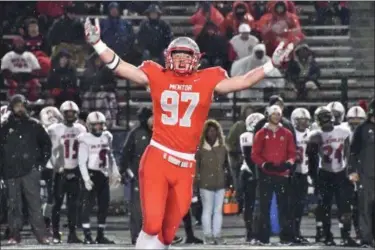 ?? NEWS-HERALD FILE ?? Noah Potter, defensive end at Mentor, celebrates a stop in the Cardinals’ regional semifinal win over Canton McKinley. Potter and the Cardinals play St. Edward on Nov. 16 for a regional championsh­ip.