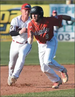  ?? NEWS PHOTO SEAN ROONEY ?? Medicine H a t Mavericks shortstop Carson Johnson tags out Okotoks Dawgs runn e r Brandon Sparks (9) during the third inning of a Western Major Baseball League game at Athletic Park Tuesday.