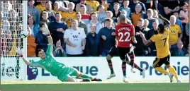  ??  ?? BREAKTHROU­GH: Cavaleiro (right) strikes for Wolves late in the second half