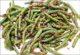  ?? The Associated Press ?? Garlic green beans. This dish is from a recipe by Melissa d’Arabian.