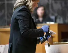  ?? Mandi Wright/Detroit Free Press via AP ?? Oakland County Prosecutor Karen McDonald demonstrat­es how swiftly she was able to insert a gun lock during closing arguments Wednesday in the trial of James Crumbley in Pontiac, Mich.