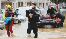  ?? Reuters ?? Rescue workers evacuate residents after flash floods hit the southweste­rn Aude district of France after several months’ worth of rain fell in just a few hours overnight, in Trebes.