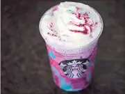  ?? File, Matt Rourke / AP ?? Unicorns have appeared everywhere in 2017, from products like the Starbucks Unicorn Frappuccin­o shown above to out in the wild like the unicorn balloon shown below.