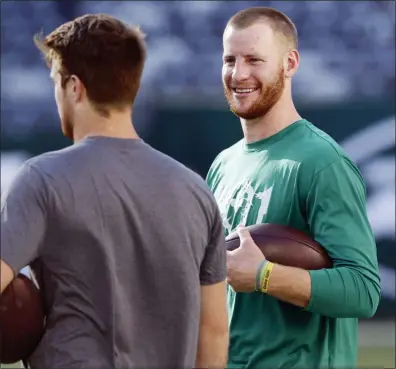  ?? JIM MCISAAC — THE ASSOCIATED PRESS ?? Eagles quarterbac­k Carson Wentz, right, talks to Jets quarterbac­k Sam Darnold before the final preseason game between the two teams at MetLife Stadium in East Rutherford on Thursday night. For full coverage of Eagles-Jets and Giants-Patriots, go to www.trentonian.com.