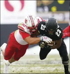  ?? Associated Press ?? MAYBE Colorado running back Jarek Broussard, center, is stopped after a short gain by Utah defensive end Maxs Tupai, left, and linebacker Devin Lloyd in the first half of an NCAA football game on Saturday in Boulder, Colo.