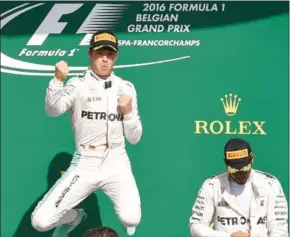  ?? JOHN THYS/AFP ?? Nico Rosberg (left) celebrates on the podium beside third-placed Lewis Hamilton after winning the Belgian Grand Prix yesterday.