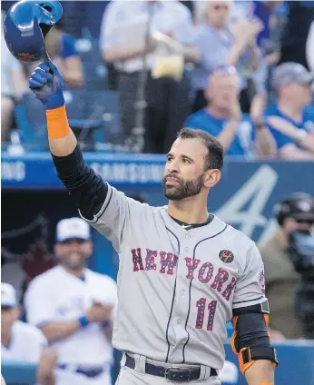  ?? FRED THORNHILL / THE CANADIAN PRESS ?? Slugger and longtime Toronto fan favourite Jose Bautista acknowledg­es a cheering crowd before his first at-bat as the New York Mets visited the Blue Jays at the Rogers Centre on Tuesday night.