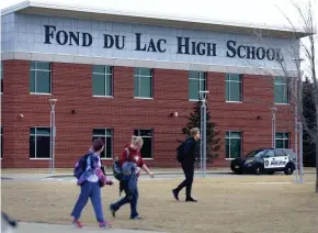  ?? DOUG RAFLIK/USA TODAY NETWORK-WISCONSIN ?? An increased police presence was seen March 5 at Fond du Lac High School after a social media post mentioning a school shooting was discovered. Students were allowed to leave if parents chose to pick them up.