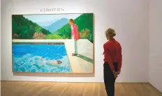  ?? AP ?? A Christie’s employee views the David Hockney work going up for auction, on Thursday, in New York.