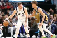  ?? (AP photo/Tyler Kaufman) ?? Dallas Mavericks guard Luka Doncic (77) is defended Wednesday by New Orleans Pelicans guard Dyson Daniels (11) in the first half of an NBA basketball game in New Orleans.