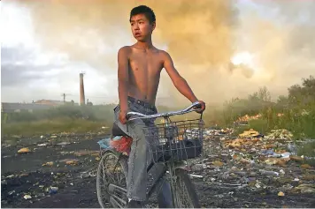  ?? (Sipa) ?? Un niño chino delante de un basurero.