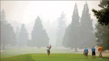  ?? ANDY NELSON/THE REGISTER-GUARD VIA AP ?? A GOLFER AT TOKATEE GOLF COURSE TEES OFF IN SMOKEY CONDITIONS at the facility near Rainbow, Ore., on Wednesday.