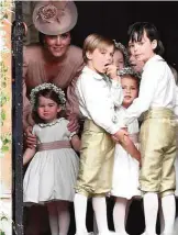  ??  ?? Britain’s Catherine, Duchess of Cambridge, left, stands with her daughter Britain’s princess Charlotte, and the other bridesmaid­s and pageboys.