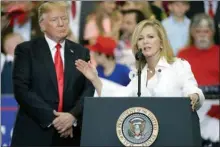  ?? The Associated Press ?? President Donald Trump listens as Rep. Marsha Blackburn, R-Tenn., speaks at a rally at the Nashville Municipal Auditorium Tuesday.