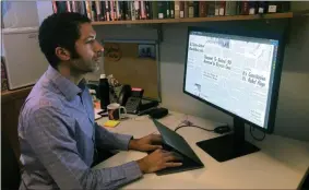  ?? MICHAEL CASEY—ASSOCIATED PRESS ?? In this Monday, Feb. 24, 2020, photo, Dartmouth College’s Matthew Delmont views the website he created, Black Quotidian, in his office on the school’s campus in Hanover, N.H. The website is an archive of digitized African-American newspaper content that highlights the lives of every day African-Americans in the 20th century. Many of the people featured were well known in their communitie­s but often were overlooked in African-American history books.