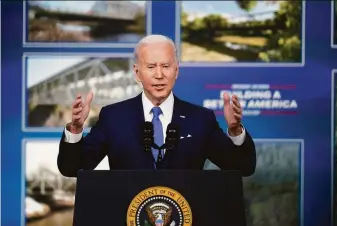  ?? Andrew Harnik / Associated Press ?? President Biden discusses a $27 billion program to repair and upgrade roughly 15,000 bridges. The initiative is part of the $1 trillion infrastruc­ture package that became law in November.