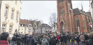  ?? MARIUS BECKER / DPA ?? People gather in front of the St. Sixtus Church on Wednesday in Haltern, Germany, during a memorial service inside commemorat­ing the victims of the Germanwing­s crash in the French Alps. Germany’s national memorial service will be April 17.