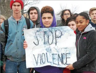  ?? KRISTI GARABRANDT — THE NEWS-HERALD ?? South High School Students Nick Anderson and Zyra Forrest hold a stop the violence sign during the students’ participat­ion in the National School Walk Out event on March 14.