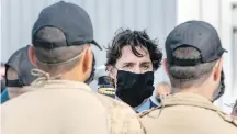  ??  ?? Prime Minister Justin Trudeau meets members of HMCS Fredericto­n’s crew after the ceremony.