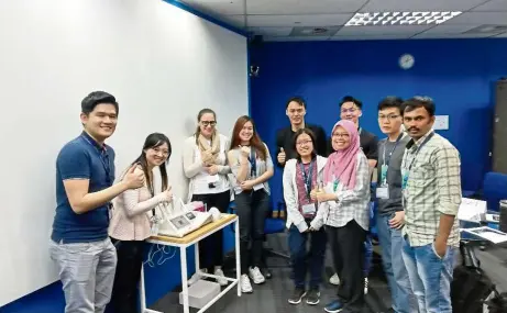  ??  ?? Part of a training workshop conducted on skin condition analysis, assisted by Dr Tan Loh Teng Hern (first from left), PhD candidate Camille Keisha Mahendra (second from left) and Dr Goh Bey Hing (middle in black suit).