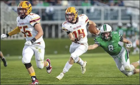  ?? Staff photo/David Pence ?? New Bremen’s Mitchell Hays rushes for a gain with an Anna defender attempting to tackle him from behind in a Midwest Athletic Conference football game on Friday.