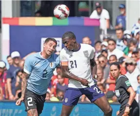  ?? DENNY MEDLEY/USA TODAY SPORTS ?? The USMNT’s Tim Weah, right, and Uruguay’s Jose Gimenez head the ball during a friendly Sunday at Children’s Mercy Park.