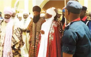  ??  ?? The emir surrounded by lieutenant­s at his palace during the coronation