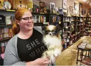  ?? Dave Rossman ?? Murder by the Book owner McKenna Jordan holds a pet, Jack Reacher, at the Bissonnet store.