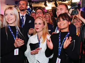  ??  ?? All smiles: Sweden Democrats backers cheer the vote results yesterday