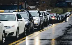  ??  ?? Vehicles line up as the Wayne County Health Department administer­s COVID-19 vaccines for anyone 80or older at a drive-thru site on Dec. 31, 2020, in Wayne, W.Va.