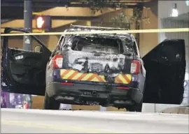  ?? Alex Slitz Associated Press ?? A POLICE CRUISER was set on fire Saturday in Atlanta. Hundreds protested officers’ killing of an activist who had shot a state trooper, according to officials.